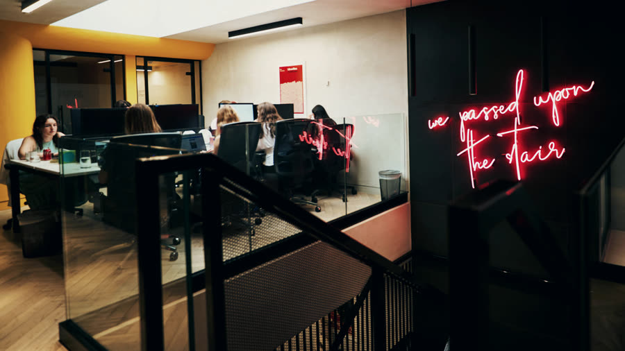 The Rostrum studio floor seen from the stairs, with its pink neon sign